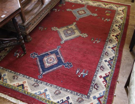 Patterned red ground Persian carpet